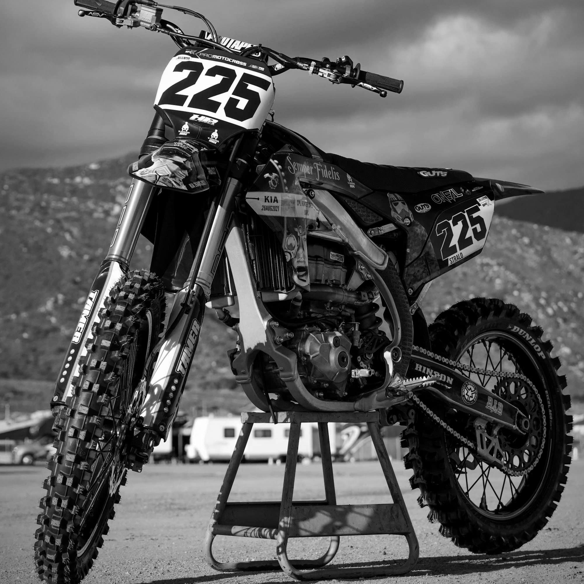 The #225 Warrior MX tribute bike honoring a fallen U.S. Marine, on a stand in the pits